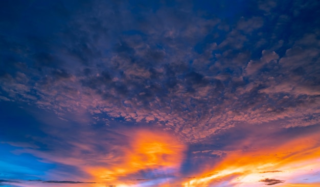 Beautiful sunset sky. Golden and orange sky and clouds with sunbeam. God light concept.