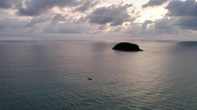 Beautiful sunset with clouds sea and island