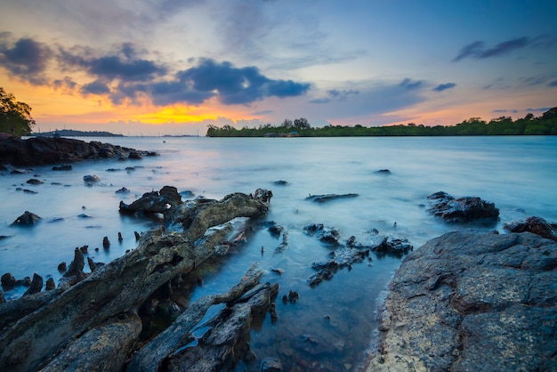 beautiful sunset with rocks along the beach