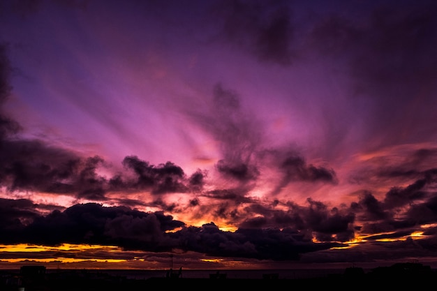 Beautiful sunset with some colors like purple and yellow with clouds - landscape amazing