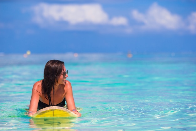 Beautiful surfer woman surfing during summer vacation