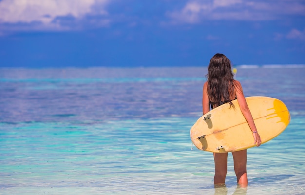 Beautiful surfer woman surfing during summer vacation