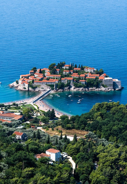 Beautiful sveti stefan island in montenegro and forest from above scenic view on adriatic sea and lu