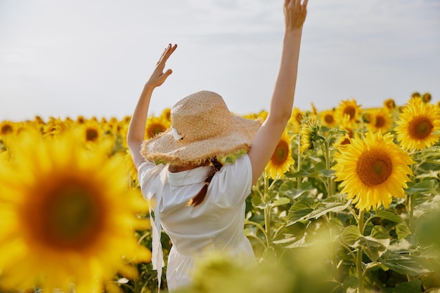 Beautiful sweet girl looking in the sunflower field landscape