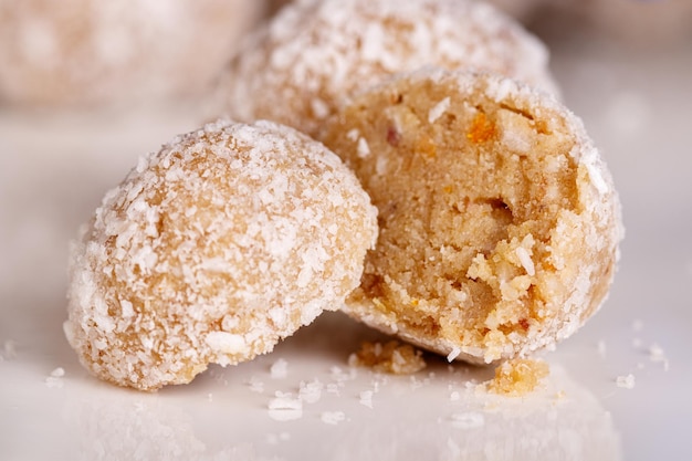 Beautiful sweets with coconut on a white plate on a black background