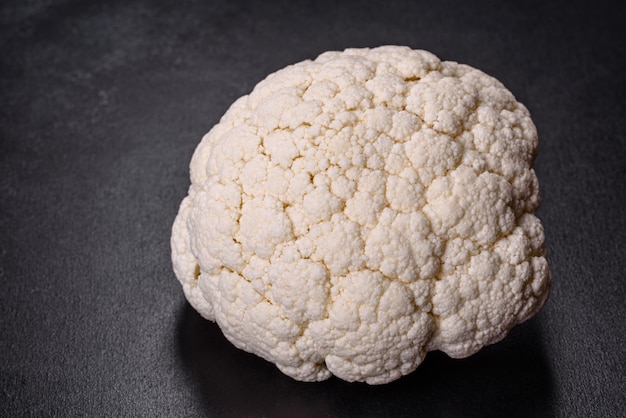 Beautiful swing of fresh white cauliflower on a dark concrete background