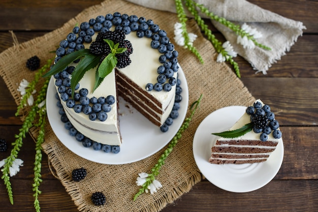 Beautiful tasty cake with white cream and berries of blueberry