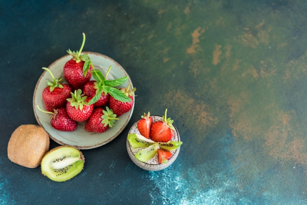 Beautiful and tasty dessert with a kiwi, strawberry and seeds of a chia