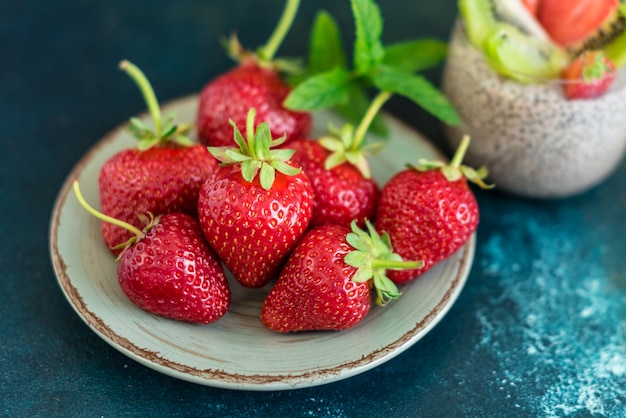 Beautiful and tasty dessert with a kiwi, strawberry and seeds of a chia