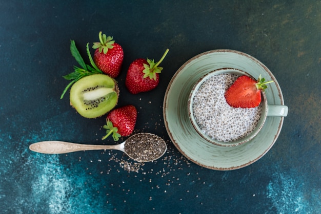 Beautiful and tasty dessert with a kiwi, strawberry and seeds of a chia