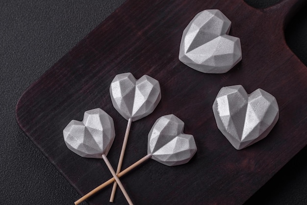 Beautiful tasty sweet candies in gray color on a dark concrete background