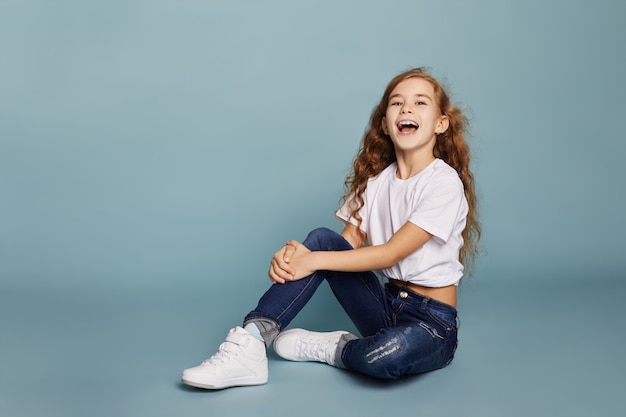 Beautiful teen girl smiling sitting on floor