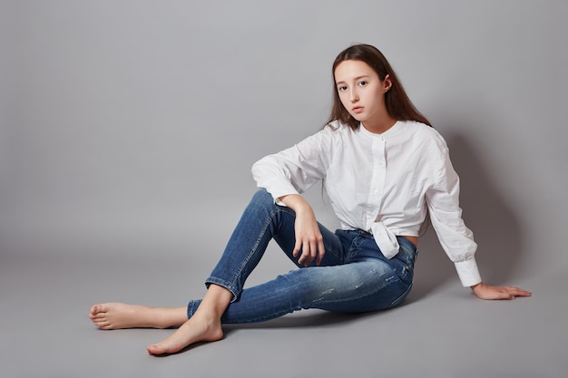 Beautiful teen girl smiling sitting on floor