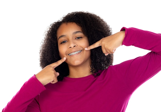 Beautiful teenager girl with dental braces isolated on a white wall