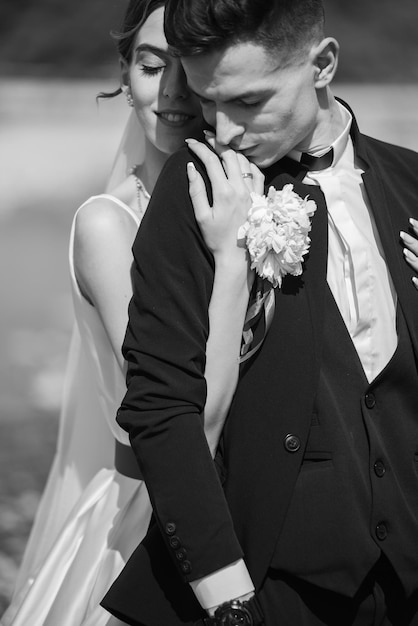 Beautiful tender young groom and wife Black and white photo