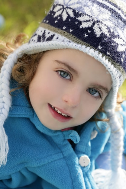 Beautiful toddler girl winter hat portrait outdoors