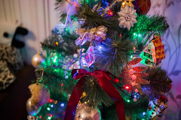 Beautiful toys on the christmas tree with garland