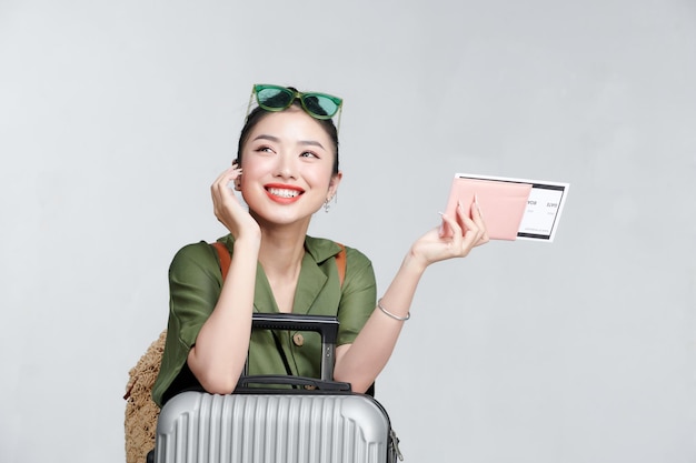 Beautiful travel woman with passport isolated on white background