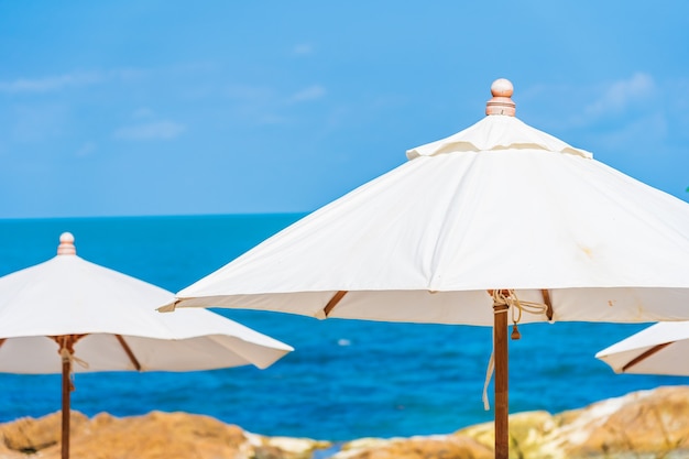 Beautiful tropical beach sea with umbrella and chair around white cloud and blue sky for vacation travel