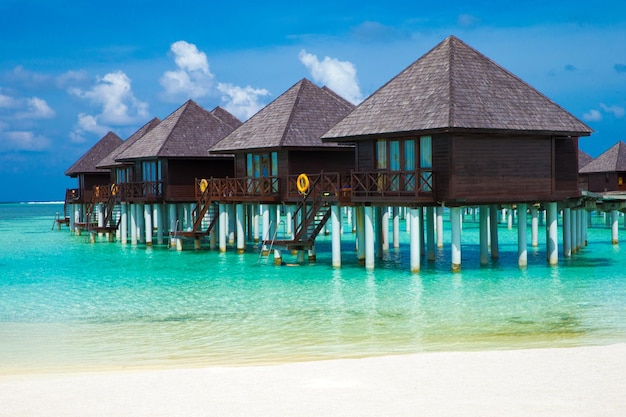 Beautiful tropical Maldives island with beach Sea with water bungalows