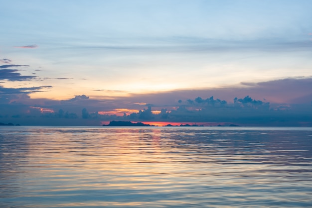 Beautiful tropical pink blue sea sunset and yellow clouds background