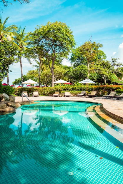 Beautiful tropical pool with umbrellas and sun beds