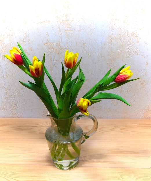 Beautiful tulip flower bouquet on wooden table top view