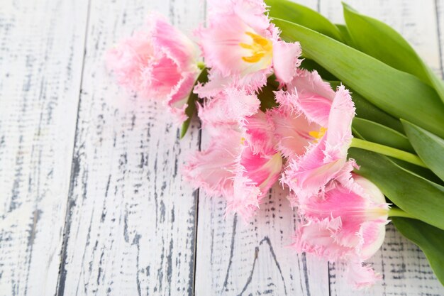 Beautiful tulips on wooden background