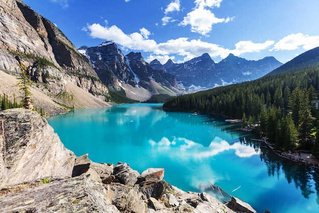 Beautiful turquoise waters of the Moraine lake with snow-covered peaks above it in Banff National Park of Canada