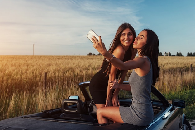 Beautiful two girls are photographed on the road