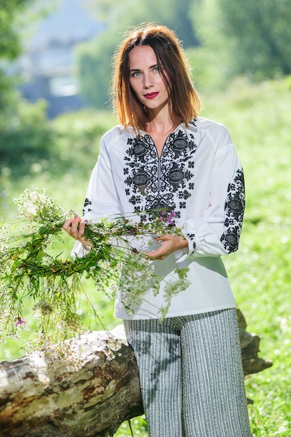 Beautiful ukrainian young woman dressed to traditional modern ethnic dress.