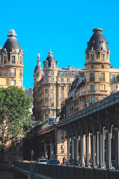 Beautiful view of architectrue buildings on the Pont de Bir-Hakeim with the metro train.