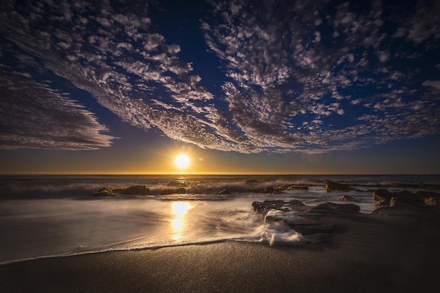 Beautiful view of a beach with times during the sunset