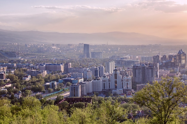 Beautiful view of the big city in the mountains at sunset