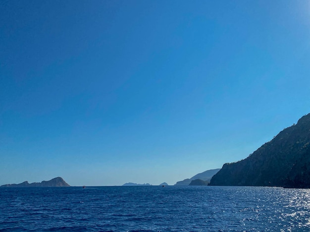 Beautiful view of the blue sea and high rocky mountains in a tourist tropical country for vacation