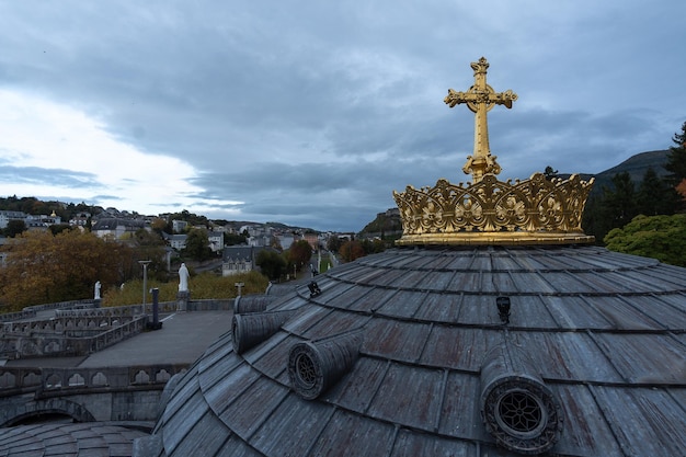 A beautiful view of Crown and cross on a dome of the Basilica Lourdes France