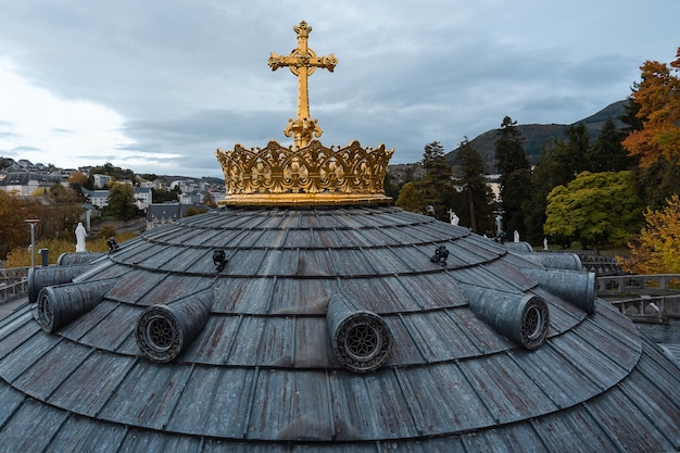 A beautiful view of Crown and cross on a dome of the Basilica of  Lourdes France