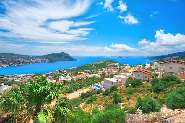 Beautiful view from the mountain to the blue sea resort town and sky with clouds