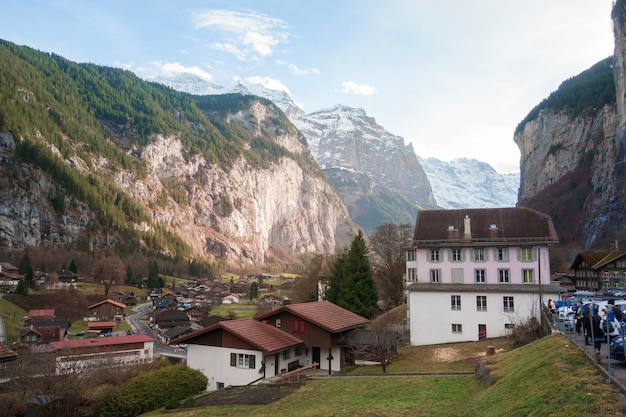 Beautiful view of Lauterbrunnen valley with waterfall and Swiss Alps background