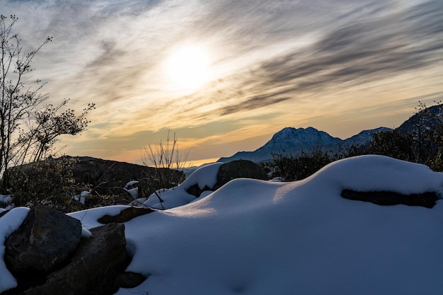 Beautiful view of mounds of snow on a cloudy day with the sun behind the clouds and La Campana