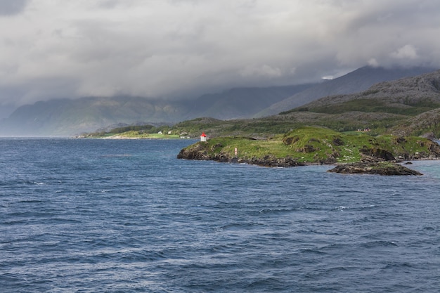 Beautiful view of the Norwegian fjords with turquoise water surrounded by cloudy sky