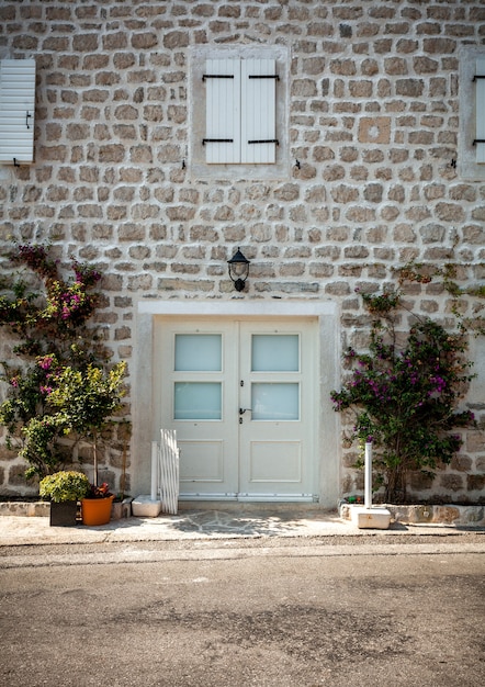 Beautiful view of old white brick wall with windows and wide doors