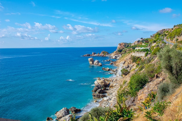 Beautiful view of the sea and rocky steep coast with banana trees