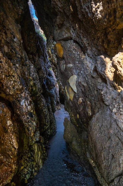 Beautiful view of secret path between rocks in Nerja beach Spain