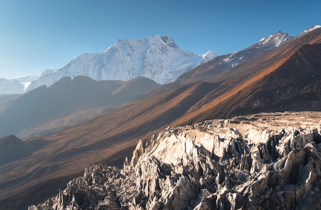 Beautiful view of snow-covered mountain against blue sky at sunrise in Nepal