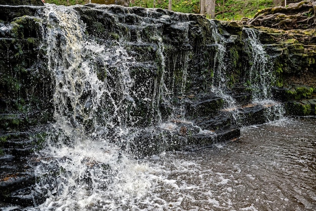 Beautiful view in spring of a waterfall on small river Ivande in Renda Latvia