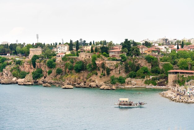 Beautiful view Tourist boat A resort town on the rocky shore