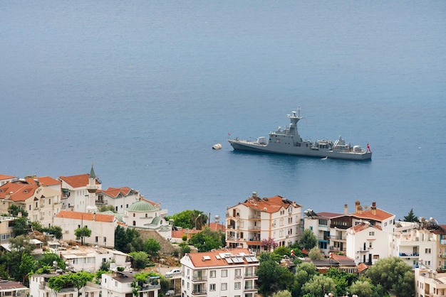 Beautiful view Warship in the sea and houses on a rocky shore