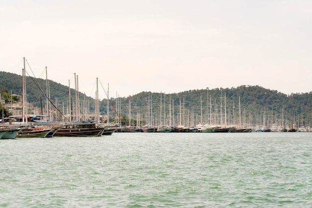 Beautiful views of the harbor with ships on a background of mountains