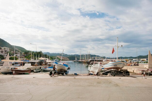 Beautiful views of the marina man standing on a paved area near the yachts